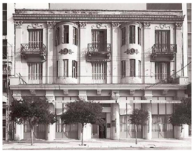 Historic exterior of Olympos Naoussa restaurant building with neoclassical balconies, Thessaloniki
